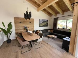 a living room with a table and a couch at Gipfelglück in Sankt Lambrecht
