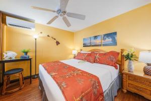 a bedroom with a bed and a ceiling fan at Napili Point A9 · NP A9 OceanFront 1BD Tropical Getaway w Ocean in Kahana +42 photos