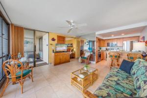 a living room with a couch and a table at Napili Point A9 · NP A9 OceanFront 1BD Tropical Getaway w Ocean in Kahana