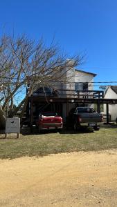a house with a car parked in front of it at Los Horneros Aparts - La Aguada in La Paloma