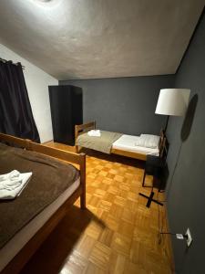 a small room with two beds and a lamp at Apartments by the sea Seline, Paklenica - 6528 in Seline