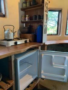 a kitchen with an open refrigerator and a stove at El Jopi in Tanti +3 photos