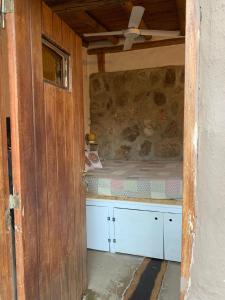 a small room with a bed in a house at El Jopi in Tanti