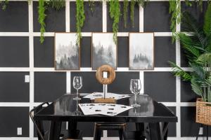 a dining room with a table and two wine glasses at Red Mountain Retreat in Leisure World +37 photos