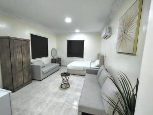 ダンマームにあるAl Qurashi Residences Al Faiha Dammamのソファとベッドのあるリビングルーム