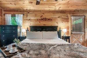 a bedroom with a bed and a wooden wall at Ever & After Cabin in Pigeon Forge