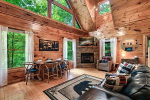 a living room with a couch and a table at Ever & After Cabin in Pigeon Forge
