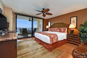 a bedroom with a bed and a balcony at Mahana 1008 · MA 1008 Luxury BeachFront Condo in Kahana +44 photos