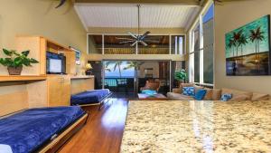 a large room with a living room with a couch at Hale Mahina B401 · HM B401 OceanFront 2BD Tropical Getaway in Kahana