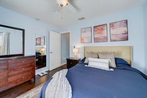 a bedroom with a blue bed and a television at BEST on the WEST Nr I295 DWTN Pet Frdly Games YRD in Jacksonville