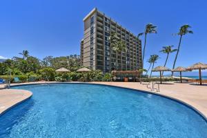 a swimming pool in front of a tall building at Royal Kahana 1020 · RK 1020 BeachFront 2BD Condo w Ocean Views A in Kahana