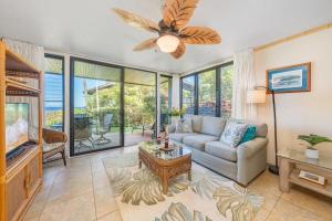 a living room with a couch and a tv at Polynesian Shores 111 · PS 111 Updated Condo w Ocean Views Pool in Kahana