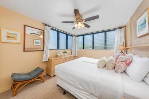 a bedroom with a bed and a ceiling fan at Polynesian Shores 111 · PS 111 Updated Condo w Ocean Views Pool in Kahana +57 photos