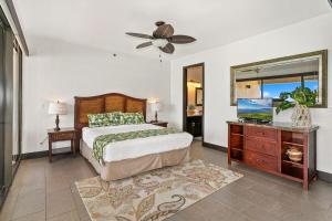 a bedroom with a bed and a ceiling fan at Sands of Kahana 354 · SK 354 Updated Maui OceanFront 2BD w Ocean in Kahana +42 photos