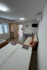 a living room with a couch and a table at Apartments with parking space Trpanj, Peljesac - 24922 in Trpanj