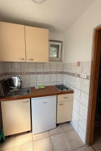 a kitchen with a sink and a counter top at Apartments with parking space Trpanj, Peljesac - 24922 in Trpanj