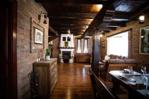 a living room with a dining table and a brick wall at Family friendly house with a parking space Andrijasevci, Slavonija - 24939 in Rokovci