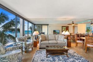 a living room with a couch and chairs and a table at Mahana 307 · MA 307 OceanFront Condo w Pool AC in Kahana