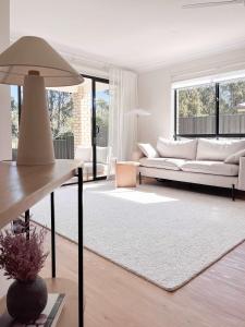 a living room with a couch and a table at Luxury 3-Bed Family Retreat Office Kayaks & Yard in Marsden