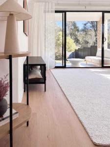 a living room with a table and a large window at Luxury 3-Bed Family Retreat Office Kayaks & Yard in Marsden +34 photos