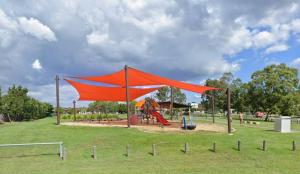 a playground with a red tent in a park at Luxury 3-Bed Family Retreat Office Kayaks & Yard in Marsden
