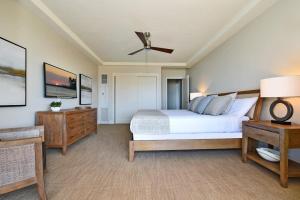 a bedroom with a bed and a ceiling fan at Whaler 859 BeachFront Luxury Condo w Ocean Views in Lahaina +43 photos