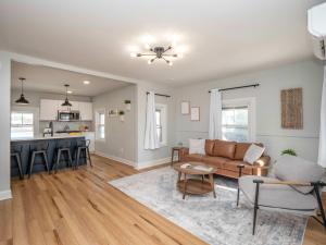 a living room with a couch and a kitchen at Jennifer's Modern & Comfy Broadway Retreat in Providence +14 photos