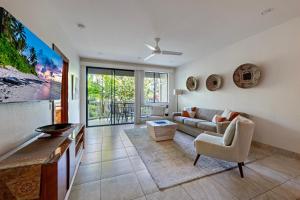 a living room with a couch and a table at Wailea Grand Champions 185 in Wailea