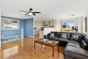 a living room with a couch and a table at Baywatch - 8 James Drive, Carrickalinga in Carrickalinga
