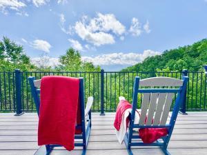 two chairs sitting on a deck with a red blanket at Mountainview Majesty in Gatlinburg