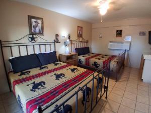 a bedroom with two beds in a room at Hill Country Lodge and Mini Storages in Buchanan Dam
