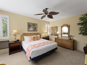a bedroom with a bed and a ceiling fan at Wailea Grand Champions 31 in Wailea