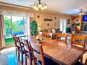 a dining room and living room with a wooden table and chairs at Mountainview Majesty in Gatlinburg +46 photos