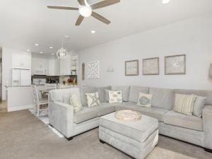 a living room with a couch and a ceiling fan at Wailea Grand Champions 27 in Wailea