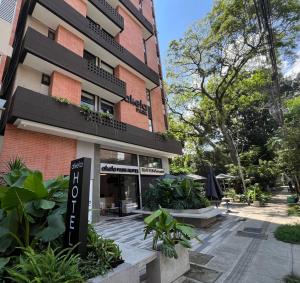 a building with a sign in front of it at Akela Park Hotel in Medellín