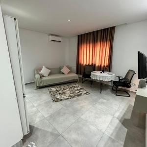 a living room with a couch and a table at La Poupée in La Marsa