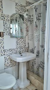 a bathroom with a sink and a toilet at Hostel - Sueños del Rio in Concepción del Uruguay