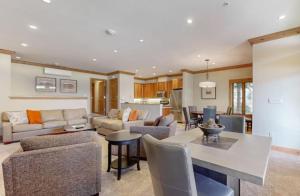a living room with a couch and a table at Luxury Ski In, Ski Out 2 Bedroom Mountain Residence In The Heart Of Lionshead Village With Heated Slope Side Pool And Hot Tub in Vail