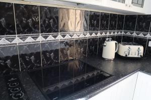a kitchen counter with a sink and a toaster at Bella Callala Holiday Home in Callala Bay