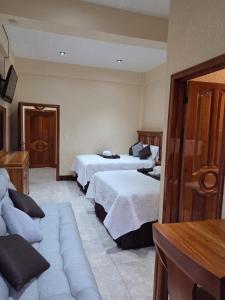 Postel nebo postele na pokoji v ubytování Hotel del Bosque, San Felipe, Retalhuleu