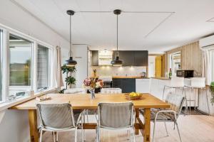 a kitchen and dining room with a wooden table and chairs at Awesome Home In Ebeltoft With 2 Bedrooms And Internet in Ebeltoft