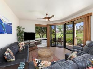 a living room with a couch and a ceiling fan at Wailea Grand Champions 159 in Wailea