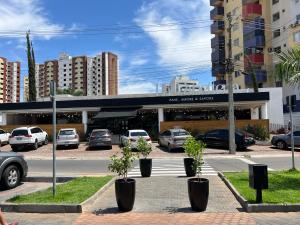 a parking lot with cars parked in front of a building at Privé Riviera Park Apt 730 in Caldas Novas