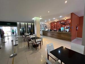 a dining room with tables and chairs in a restaurant at Privé Riviera Park Apt 730 in Caldas Novas