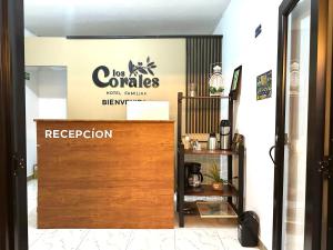 a coffee shop with a sign on the wall at Hotel Los Corales Mutata in Mutatá
