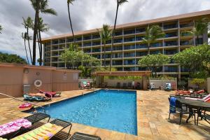 a swimming pool in front of a hotel at Kihei Akahi D402 · AKH D402 2BD Condo Across Beach Ocean View AC in Wailea