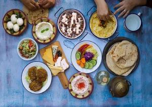 a table full of different types of food on plates at City Stars Hotel in Cairo