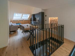 a kitchen and dining room with a staircase in a house at Holiday Home in La Roche with Castle Views in La Roche-en-Ardenne