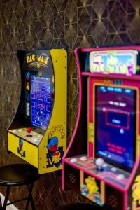 two arcade games sitting next to each other at Movie Theater-Game Room-Parking-Heart Of Cleveland in The Angle