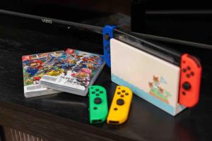 a table with two video games and two controllers at Movie Theater-Game Room-Parking-Heart Of Cleveland in The Angle